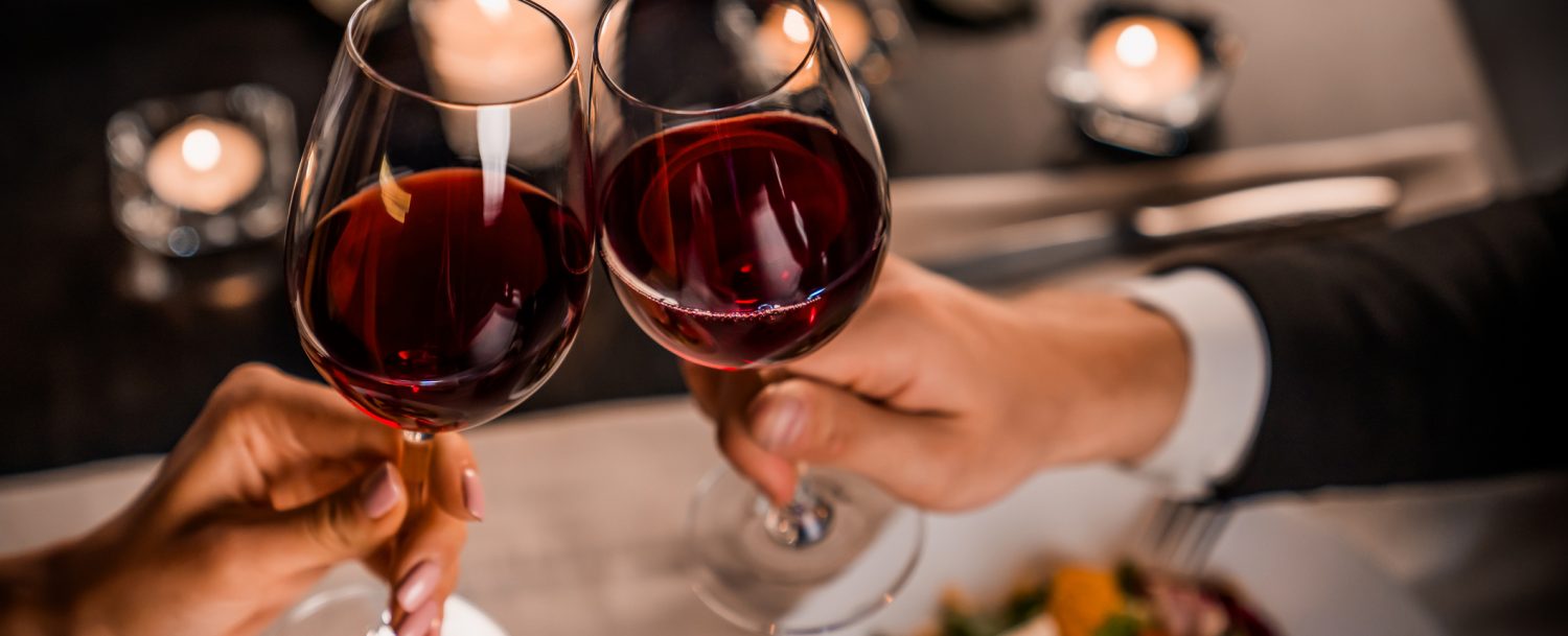 Couple out to dinner toasting wine glasses